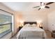 Comfortable main bedroom with a ceiling fan and a large window at 5253 1St N Ave, St Petersburg, FL 33710
