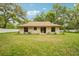 Home featuring sliding glass doors to a large backyard, ideal for relaxing or entertaining at 6231 Massey Rd, Zephyrhills, FL 33542