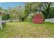 Spacious fenced backyard featuring a storage shed and mature trees for added privacy at 6231 Massey Rd, Zephyrhills, FL 33542