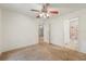 Bedroom with ceiling fan, and access to the bathroom and another room at 6231 Massey Rd, Zephyrhills, FL 33542
