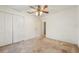 Bedroom with a ceiling fan, a closet with folding doors, and an entrance at 6231 Massey Rd, Zephyrhills, FL 33542