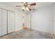 Bedroom with ceiling fan and closet storage at 6231 Massey Rd, Zephyrhills, FL 33542