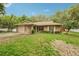 Well maintained exterior, green lawn, and mature trees create this single-Gathering home's curb appeal at 6231 Massey Rd, Zephyrhills, FL 33542