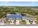 Aerial view of community showing homes with private backyards and a large pond at 6674 Cobble Bliss St, Zephyrhills, FL 33541