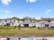 Exterior home view featuring fenced in backyards, grass, and a pond at 6674 Cobble Bliss St, Zephyrhills, FL 33541