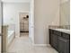 Bright bathroom with granite countertops and walk-in closet at 6674 Cobble Bliss St, Zephyrhills, FL 33541
