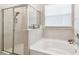 Bathroom featuring tub, separate shower and tile surround at 6674 Cobble Bliss St, Zephyrhills, FL 33541