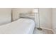 Minimalist bedroom design with a light wood headboard and a floor lamp at 6674 Cobble Bliss St, Zephyrhills, FL 33541
