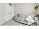 Cozy bedroom featuring a comfortable sofa and closet with bi-fold doors at 6674 Cobble Bliss St, Zephyrhills, FL 33541
