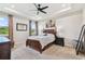 Comfortable bedroom with trey ceiling, fan and natural light at 6674 Cobble Bliss St, Zephyrhills, FL 33541