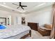 Spacious bedroom featuring a tray ceiling and an accent chair at 6674 Cobble Bliss St, Zephyrhills, FL 33541