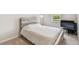 Cozy bedroom features a unique wood headboard and plenty of natural light from the window at 6674 Cobble Bliss St, Zephyrhills, FL 33541