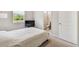 Bright bedroom has a window, access to a bathroom, and neutral carpeting at 6674 Cobble Bliss St, Zephyrhills, FL 33541