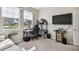 Bedroom with natural light, including a gaming setup with desk and tv at 6674 Cobble Bliss St, Zephyrhills, FL 33541