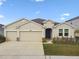 Charming one-story home with a two car garage, well-maintained lawn, and neutral stucco exterior at 6674 Cobble Bliss St, Zephyrhills, FL 33541