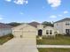 Charming one-story home with a two car garage, well-maintained lawn, and neutral stucco exterior at 6674 Cobble Bliss St, Zephyrhills, FL 33541