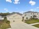 Charming one-story home with a two car garage, well-maintained lawn, and neutral stucco exterior at 6674 Cobble Bliss St, Zephyrhills, FL 33541