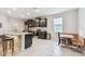 Bright, open kitchen with granite countertops, stainless steel appliances, and breakfast nook at 6674 Cobble Bliss St, Zephyrhills, FL 33541