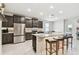 Spacious kitchen boasts stainless steel appliances, granite countertops, and breakfast bar seating at 6674 Cobble Bliss St, Zephyrhills, FL 33541