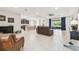 Open-concept living area with modern kitchen access and scenic backyard views at 6674 Cobble Bliss St, Zephyrhills, FL 33541