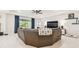 Cozy living room with entertainment center, sectional sofa and backyard views at 6674 Cobble Bliss St, Zephyrhills, FL 33541