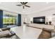 Spacious living room with serene outdoor views, modern fixtures and plush seating at 6674 Cobble Bliss St, Zephyrhills, FL 33541