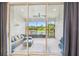 Enclosed patio with comfortable seating and a scenic waterfront view at 6674 Cobble Bliss St, Zephyrhills, FL 33541