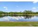 Enjoy serene waterfront views from the backyard's picturesque pond at 6674 Cobble Bliss St, Zephyrhills, FL 33541