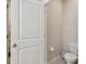 Powder room featuring a toilet, toilet paper holder, and small garbage can at 6674 Cobble Bliss St, Zephyrhills, FL 33541
