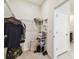 Spacious walk-in closet with wire shelving and visible tiled flooring outside the door at 6674 Cobble Bliss St, Zephyrhills, FL 33541