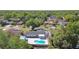 A home features a paved back yard with a pool, a sunroom, and a cabana at 706 Caliente Dr, Brandon, FL 33511