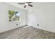 Bright bedroom features wood-look tile flooring, ceiling fan, and closet at 706 Caliente Dr, Brandon, FL 33511