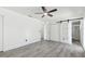 Bedroom features wood-look tile flooring, ceiling fan, closet, and bathroom access at 706 Caliente Dr, Brandon, FL 33511