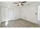 Bright bedroom featuring light gray flooring, closet with white doors and a ceiling fan at 706 Caliente Dr, Brandon, FL 33511