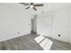 Bright bedroom features wood-look tile flooring, ceiling fan, and closet at 706 Caliente Dr, Brandon, FL 33511