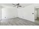 Bedroom features wood-look tile flooring, ceiling fan, closet, and white walls at 706 Caliente Dr, Brandon, FL 33511
