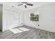 Bright bedroom features wood-look tile flooring, ceiling fan, and closet at 706 Caliente Dr, Brandon, FL 33511