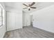 Bedroom with gray floors, ceiling fan, closet, and views of the backyard pool area at 706 Caliente Dr, Brandon, FL 33511