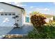 Home's exterior with a neatly landscaped front yard and a vibrant blue front door at 706 Caliente Dr, Brandon, FL 33511