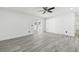 Bright living room with gray wood-look flooring and French doors to backyard at 706 Caliente Dr, Brandon, FL 33511