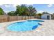 Backyard featuring a sparkling swimming pool with a paved deck, and a fenced yard at 706 Caliente Dr, Brandon, FL 33511