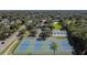 An aerial shot shows the community's tennis courts and clubhouse, surrounded by lush landscaping at 706 Caliente Dr, Brandon, FL 33511
