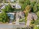 Residential neighborhood aerial view showcases lush landscaping, and private screened in pool at 775 Brittany Park Blvd, Tarpon Springs, FL 34689