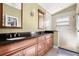 Bathroom featuring double sinks, dark countertops, and a glass shower at 775 Brittany Park Blvd, Tarpon Springs, FL 34689