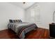 Bedroom with wood floors, window with shutters, and calming blue accents at 775 Brittany Park Blvd, Tarpon Springs, FL 34689