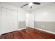 Bedroom features hardwood floors, a ceiling fan, and neutral colored walls at 775 Brittany Park Blvd, Tarpon Springs, FL 34689
