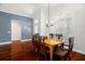 Dining room features hardwood floors, large window, and chandelier at 775 Brittany Park Blvd, Tarpon Springs, FL 34689