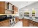 Kitchen offers stainless steel appliances, tile backsplash, and lots of natural light at 775 Brittany Park Blvd, Tarpon Springs, FL 34689