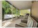 Cozy lanai with comfortable striped couches, perfect for relaxing and enjoying the outdoors at 775 Brittany Park Blvd, Tarpon Springs, FL 34689