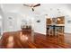Open concept kitchen and living area featuring hardwood flooring and neutral color scheme at 775 Brittany Park Blvd, Tarpon Springs, FL 34689